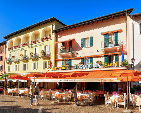 Ascona, Switzerland - August 23, 2016: Restaurants and cafes at the luxurious resort in Ascona on Lake Maggiore of Ticino canton, Switzerland. People on the background.のeditorial素材