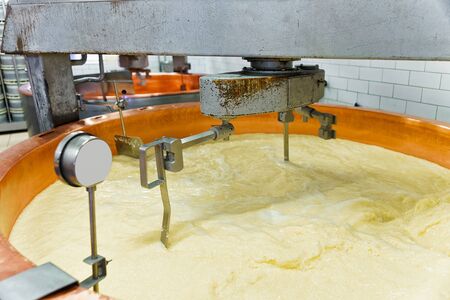 Production of Gruyere de Comte Cheese at the dairy in Franche Comte, Burgundy, in France.の写真素材