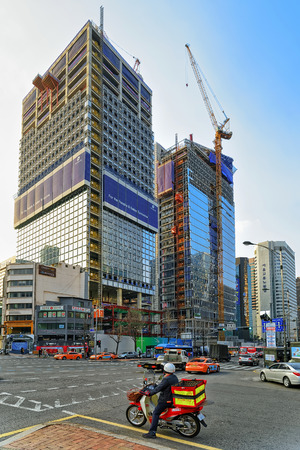 Seoul, South Korea - March 14, 2016: Skyscrapers and car traffic in the road of Jongno district in Seoul, South Korea. People on the backgroundのeditorial素材