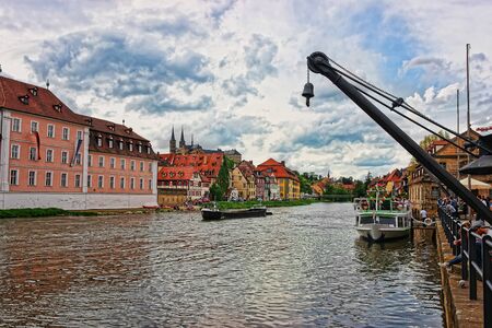 Bamberg, Germany - May 9, 2013: Ship, Fishermen houses and Regnitz River in the Little Venice in Bamberg in Upper Franconia, Bavaria, Germany. People on the backgroundのeditorial素材
