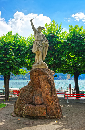 Statue of William Tell at the promenade of the luxurious resort in Lugano on Lake Lugano and Alps mountains in Ticino canton of Switzerland.のeditorial素材