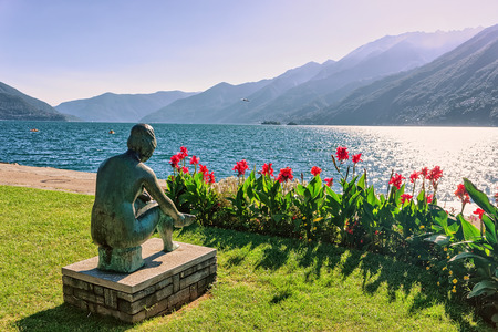 Sitting woman sculpture at the promenade at the luxurious resort in Ascona on Lake Maggiore in Ticino canton in Switzerland.のeditorial素材