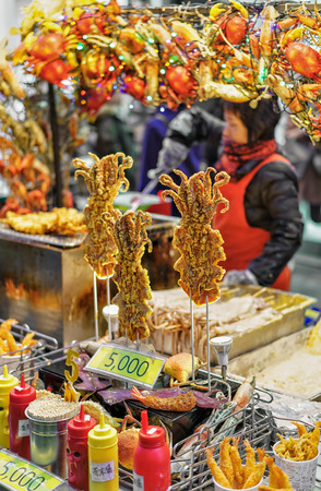 Seoul, South Korea - March 14, 2016: Woman selling seafood at Myeongdong street market in Seoul, South Koreaのeditorial素材