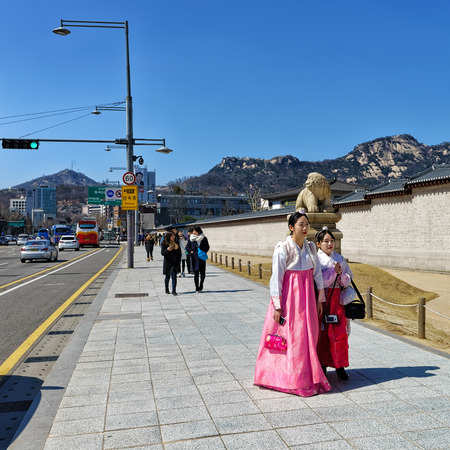 Seoul, South Korea - March 11, 2016: Young girls in traditional costumes near Gyeongbokgung Palace in Seoul, South Koreaのeditorial素材