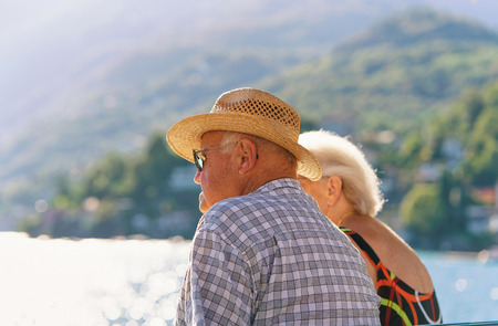 Ascona, Switzerland - August 23, 2016: Senior Couple sitting on the bench at the embankment of Ascona expensive resort on Lake Maggiore, Ticino canton of Switzerland.のeditorial素材