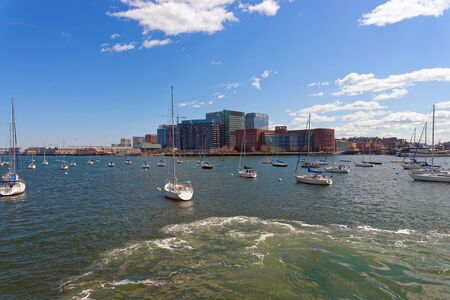 Boston, USA - April 28, 2015: Yachts at Boston Wharf of Charles River and Financial district on the background, Boston, Massachusetts, the United States.のeditorial素材