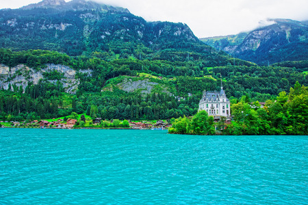 Mansion at Lake Brienz and Brienzer Rothorn mountain at Interlaken in Canton of Bern in Switzerlandのeditorial素材