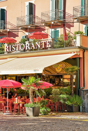 Ascona, Switzerland - August 23, 2016: Street Restaurant at Ascona town on Lake Maggiore in Ticino canton in Switzerland. People on the background.のeditorial素材