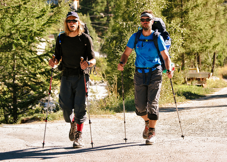 Zermatt, Switzerland - August 24, 2016: People doing nordic walking at resort city in Switzerland in summer.のeditorial素材
