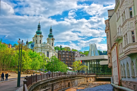 Tepla River embankment and St Mary Magdalene Church, Karlovy Vary, Czech republic. People on the background.のeditorial素材