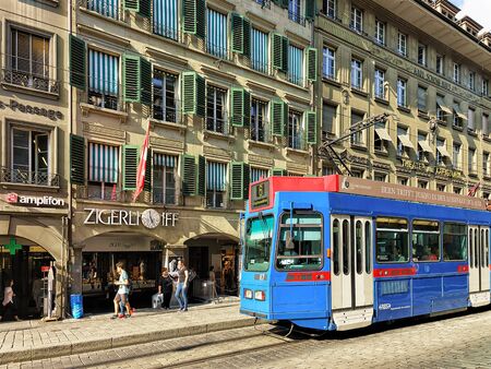 Bern, Switzerland - August 31, 2016: Running tram and people in Spitalgasse street with shopping area in old city center of Bern, Switzerlandのeditorial素材