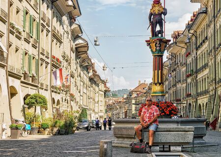 Bern, Switzerland - August 31, 2016: People at Zahringen fountain on Kramgasse street with shopping area in old city center of Bern, Switzerlandのeditorial素材