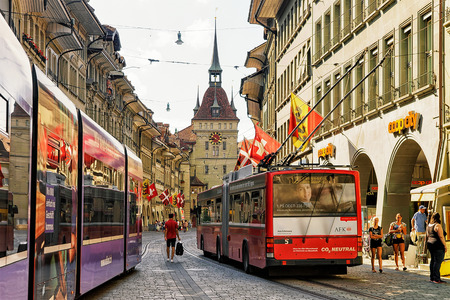 Bern, Switzerland - August 31, 2016: Running trams and people at Kafigturm tower on Marktgasse street with shopping area in old city center of Bern, Switzerlandのeditorial素材