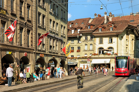 Bern, Switzerland - August 31, 2016: Running tram and people at Spitalgasse street with shopping area in old city center of Bern, Switzerlandのeditorial素材
