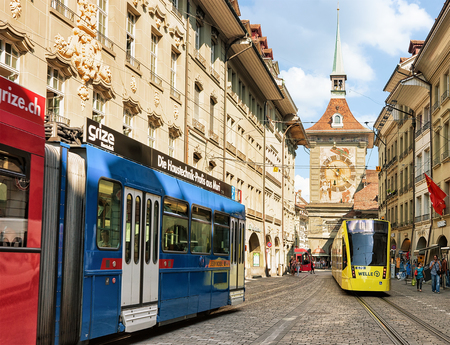 Bern, Switzerland - August 31, 2016: Trams and People at Zytglogge clock tower on Kramgasse street...