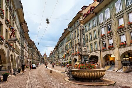 Bern, Switzerland - August 31, 2016: People at Kreuzgassbrunnen on Kramgasse street with shopping area in old city center of Bern, Switzerlandのeditorial素材