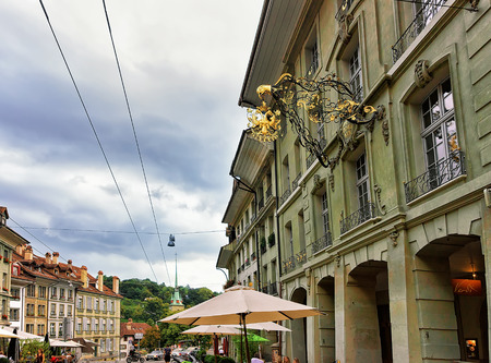 Bern, Switzerland - August 31, 2016: Cafe and people at Kramgasse street with shopping area in old...