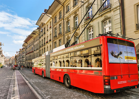 Bern, Switzerland - August 31, 2016: Running tram on Kramgasse street with shopping area in old city center of Bern, Switzerland. People on the backgroundのeditorial素材