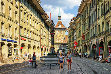 Bern, Switzerland - August 31, 2016: People at Schutzenbrunnen and Zytglogge clock tower on...
