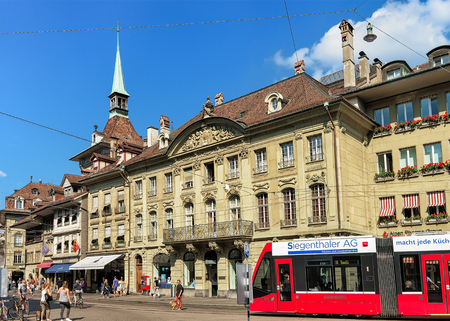 Bern, Switzerland - August 31, 2016: People and running tram on Theaterplatz in old city center of...