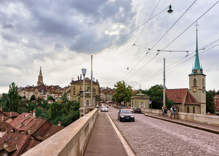 Bern, Switzerland - August 31, 2016: Nudeggbrucke bridge with transport and Nydegg Church in Bern, Switzerland. People on the bridgeのeditorial素材
