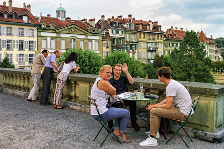 Bern, Switzerland - August 31, 2016: Friends at open air cafe on Munsterplatform in old city center...