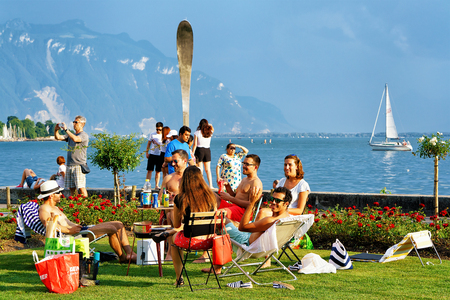 Vevey, Switzerland - August 27, 2016: People having fun at Geneva Lake of Vevey, Vaud canton, Switzerland. Alps mountains on the backgroundのeditorial素材