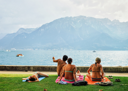 Vevey, Switzerland - August 27, 2016: People sunbathing at the embankment of Geneva Lake in Vevey, Vaud canton, Switzerlandのeditorial素材