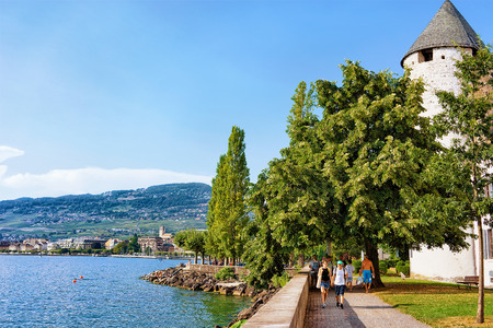 Vevey, Switzerland - August 27, 2016: People at promenade with Alps mountains and Geneva Lake Riviera in Vevey, Vaud canton, Switzerland.のeditorial素材