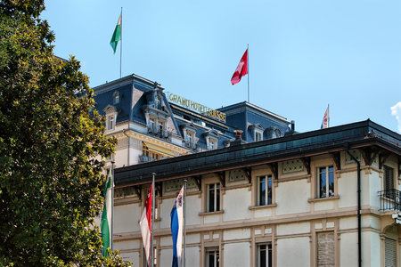 Montreux, Switzerland - August 27, 2016: Facade of Luxury hotel with Swiss flag on Geneva Lake Riviera at Montreux, Vaud canton, Switzerlandのeditorial素材