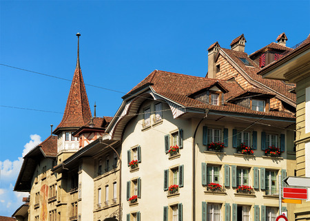 Historical building with spire on Hotelgasse street in old city center of Bern, Switzerland