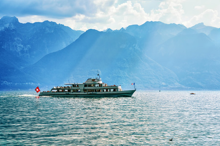 Excursion ferry at Geneva Lake in Vevey, Vaud canton of Switzerland. Alps mountains and people on the backgroundの写真素材