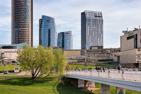 Vilnius, Lithuania - April 30, 2016: Downtown with skyscrapers and people on White bridge in the city center of Vilnius, Lithuania, in springのeditorial素材