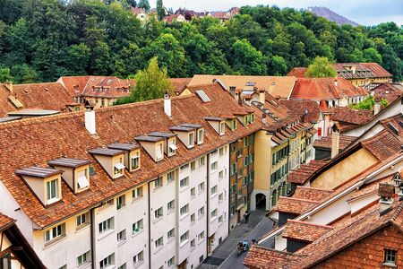 Street with old houses rooftops in Bern, Switzerland. Seen from Nydeggbrucke bridgeの写真素材