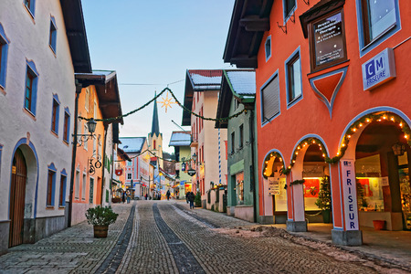 Garmisch-Partenkirchen, Germany - January 6, 2015: Spire of Maria Himmelfahrt Assumption day church in the street decorated for Christmas in Garmisch-Partenkirchen, Germany. People on the backgroundのeditorial素材