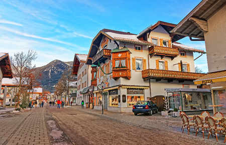 Garmisch-Partenkirchen, Germany - January 6, 2015:  Chalets in Bavarian style decorated for Xmas at Garmisch Partenkirchen old town, Germany. People on the backgroundのeditorial素材