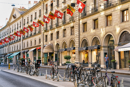 Geneva, Switzerland - August 30, 2016: Bicycles on Rue de la Corraterie Street with Swiss flags in the center in Geneva, Switzerland. People on the backgroundのeditorial素材
