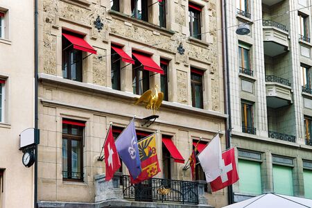 Flags on buildings at Place Longemalle Square in Geneva city center, Switzerlandの写真素材