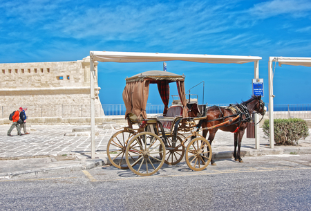 Valletta, Malta - April 3, 2014: Horse fiacre with people at St Elmo fort in Valletta, Maltaのeditorial素材