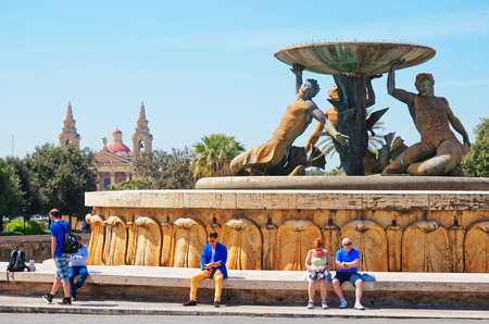 Valletta, Malta - April 3, 2014:  People at Triton fountain at the City Gate into Valletta old town, Maltaのeditorial素材
