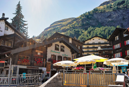 Zermatt, Switzerland - August 24, 2016: Street with people arount Wooden traditional Swiss chalets in mountains, Zermatt, Switzerland in summerのeditorial素材
