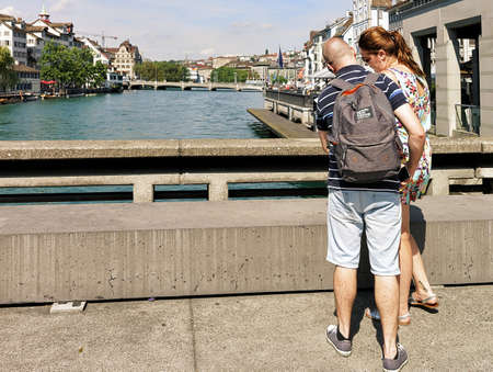 Zurich, Switzerland - September 2, 2016: People with the city map at Limmat River embankment in Zurich, Switzerlandのeditorial素材