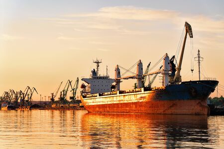 Ship in Baltic sea in Port, Klaipeda, Lithuania. Golden light at sunset