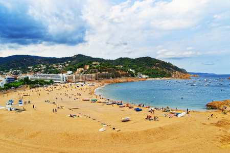 Beach and people in Tossa de Mar on the Costa Brava at the Mediterranean Sea in Spain.の写真素材