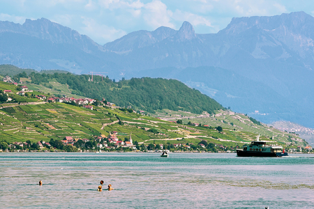 Lausanne, Switzerland - August 26, 2016: People swimming and sunbathing at Lakefront of Lake Geneva, Lausanne, Switzerland.のeditorial素材