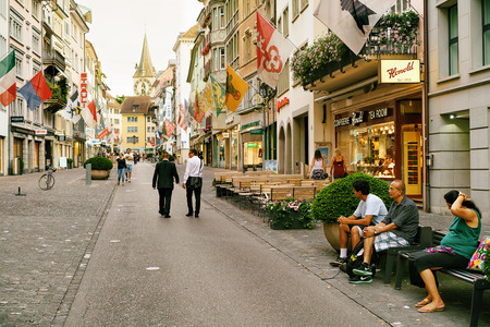 Zurich, Switzerland - September 2, 2016: People at Rennweg pedestrian Street with a view on Saint Peter Church in the old city center of Zurich, Switzerlandのeditorial素材
