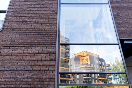 Reflection in a glass window of Modern architectural complex of apartment residential buildings. And outdoor facilities.のeditorial素材