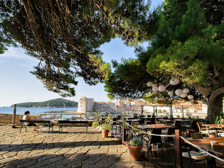 Dubrovnik, Croatia - August 19, 2016: Woman on the Bench at the Old town of Dubrovnik and the Adriatic Sea, Croatiaのeditorial素材