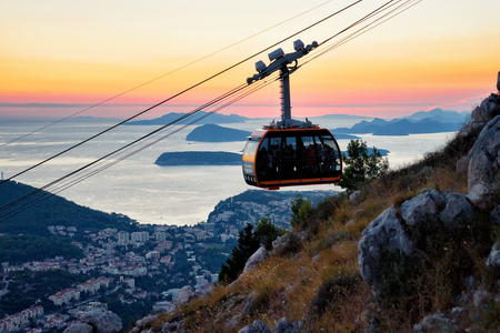 Cabin of cableway and ancient town of Dubrovnik at sunset on the background, Croatiaのeditorial素材