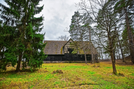 Riga, Latvia - December 27, 2011: Old wooden house at Ethnographic open air village in Riga, Latviaのeditorial素材